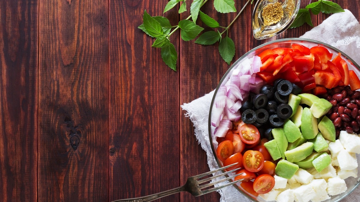 Bowl of vegetable salad with avocado and cheese